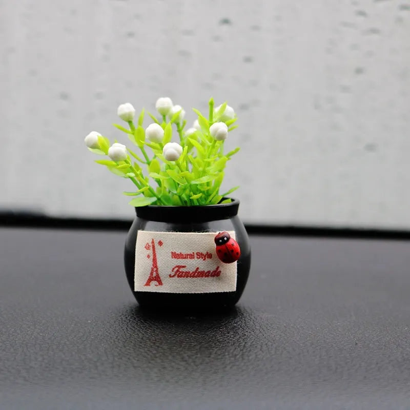 Auspicious fruit potted plant car ornament in a plastic vase, available in black or white, for car interior decoration and odour removal