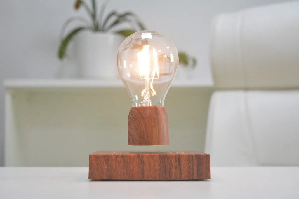 Magnetic levitation floating light bulb hovering above a wood-effect base.
