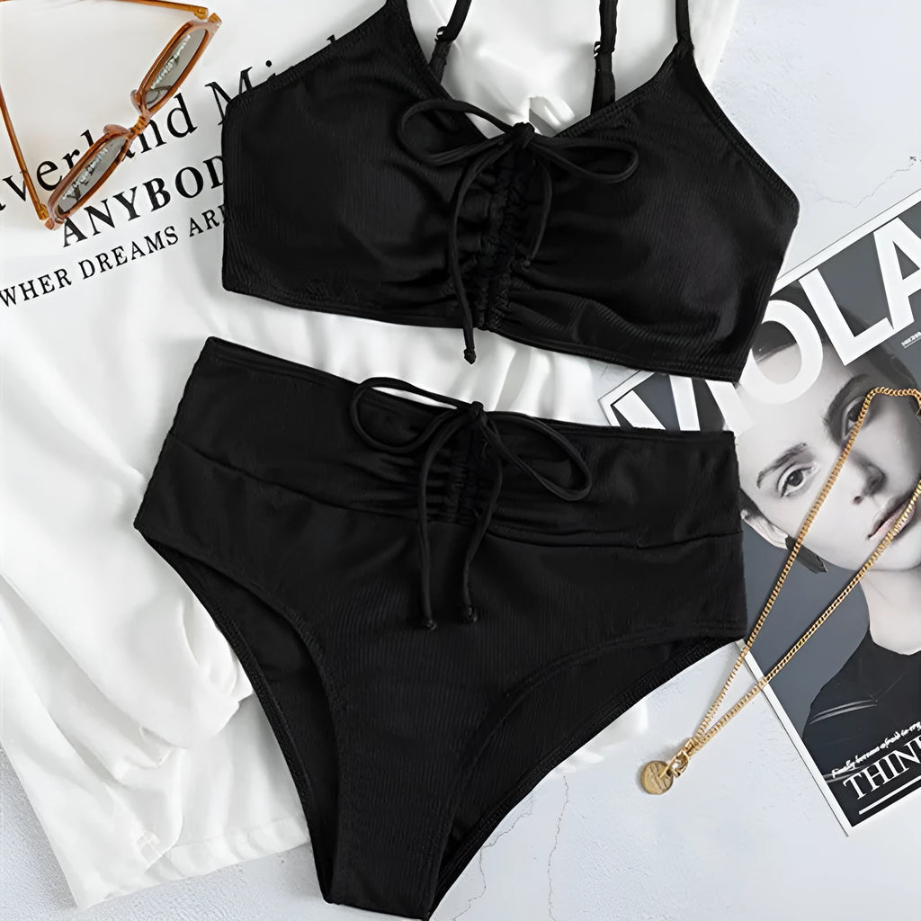 Black women's bikini swimsuit with high waist shorts and a sleeveless top on a mannequin.