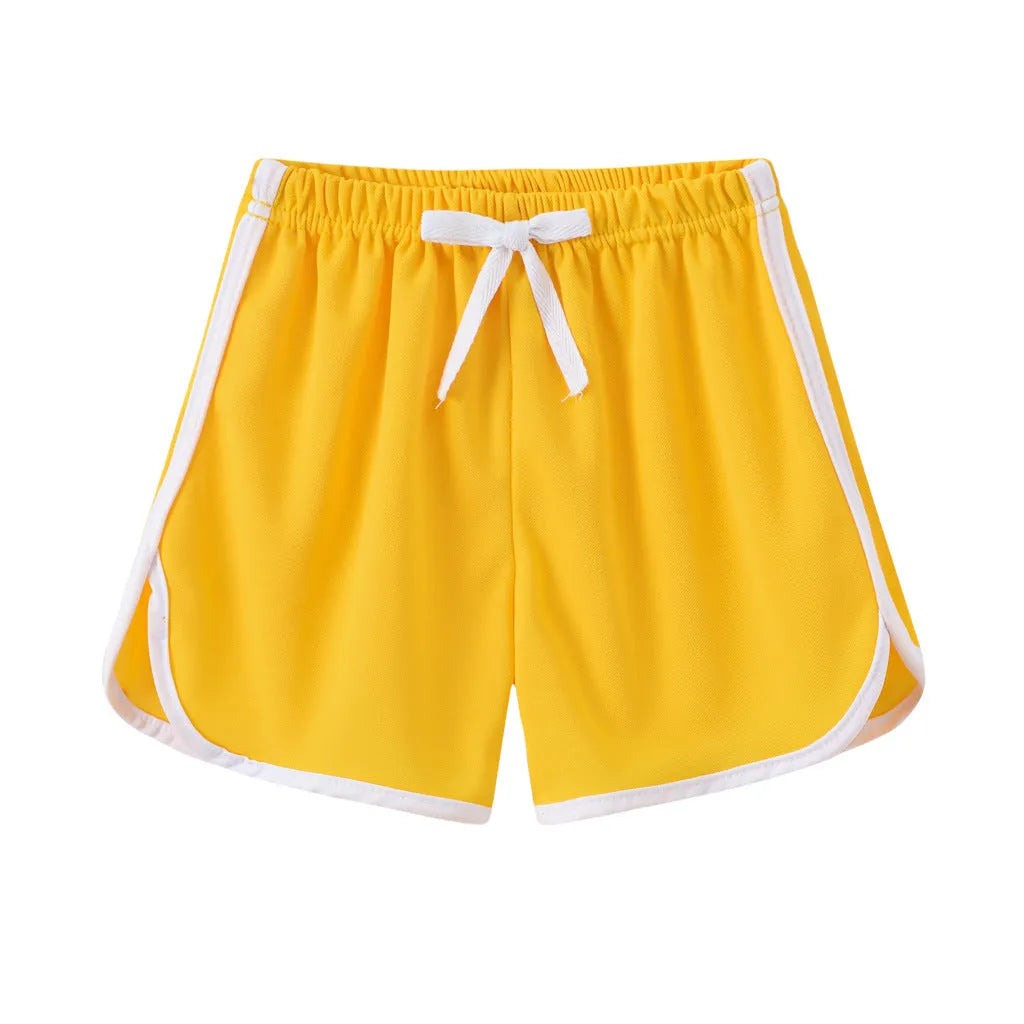 Children's colourful polyester shorts with elastic waistband, showing patterns like stripes, pineapples, and kittens.