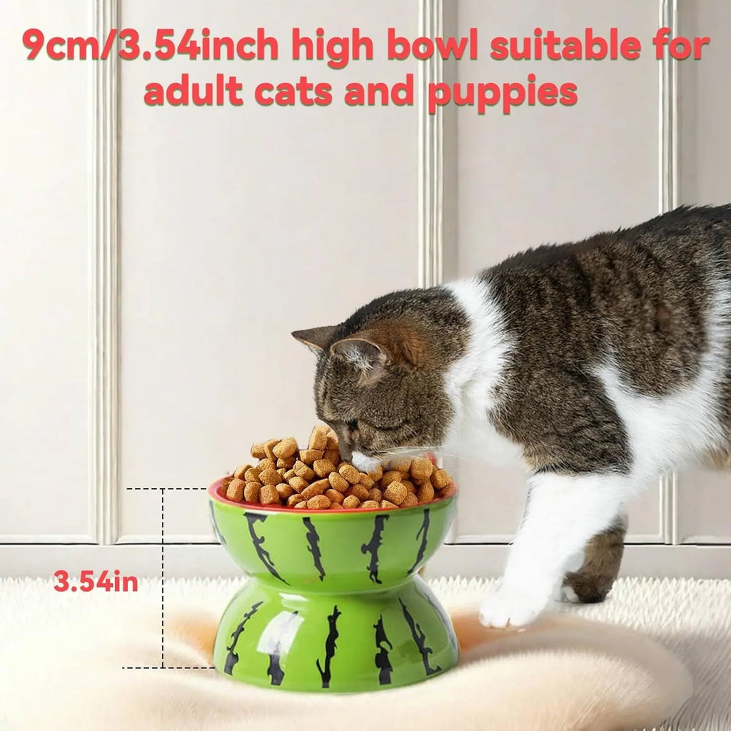 Ceramic raised cat bowl in orange pattern, showing tilted wide dish on non-slip base.