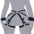 Black leather-look belt with metal buckle and bow detail, handcuffs from same set, on a dark surface
