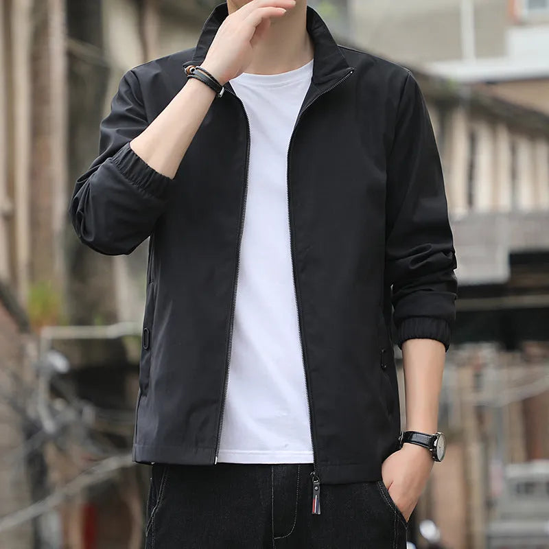 Man wearing a loose-fit Korean style casual jacket in blue, with zip-up front and pocket detail.