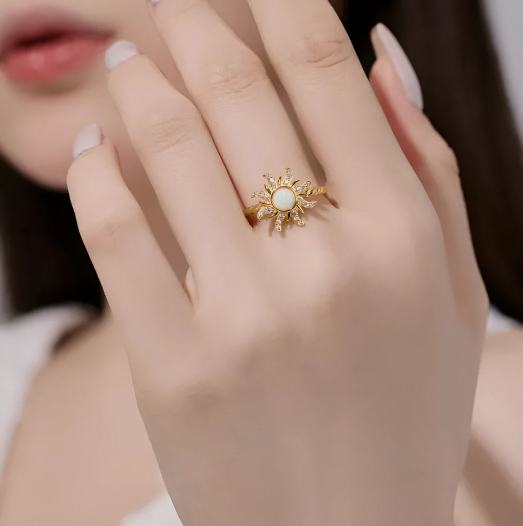 Women's silver ring with inlaid sun design and electroplated finish, shown in one of four colour options