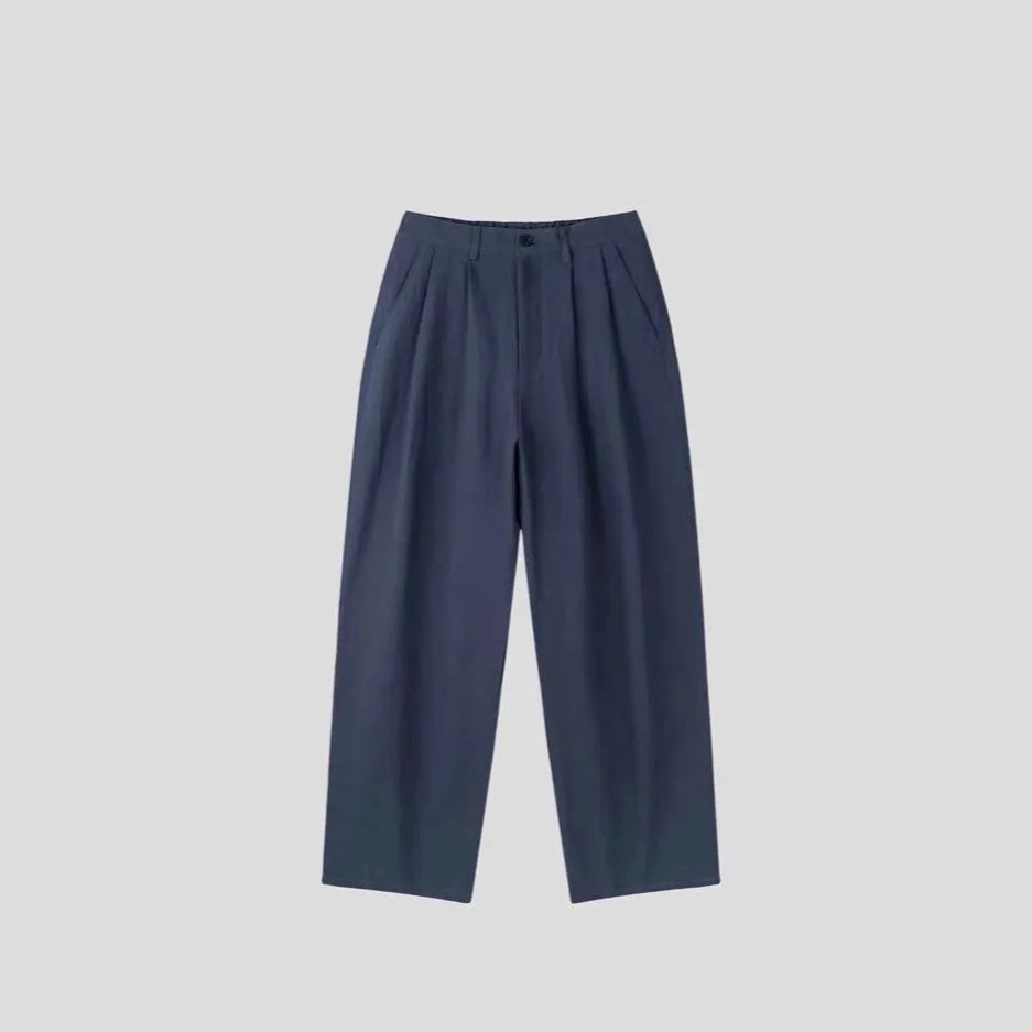 Men's apricot loose-fit cotton linen trousers with a pencil pants leg opening and micro-elastic waistband.