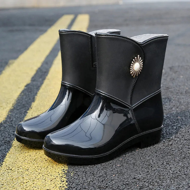 Women's mid-calf PVC rain boots in purple, black, or beige with a non-slip sole.