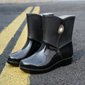 Women's mid-calf PVC rain boots in purple, black, or beige with a non-slip sole.