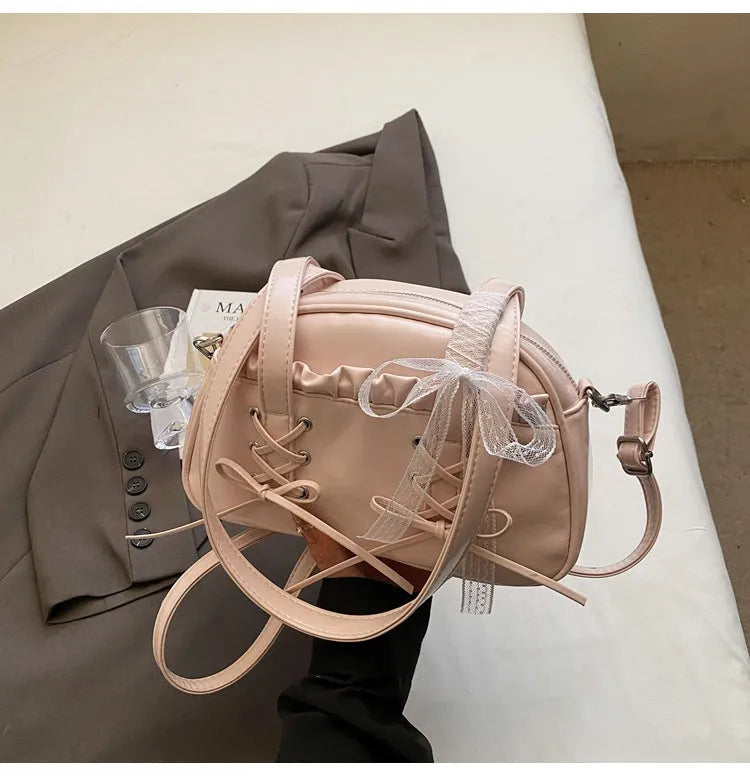 PU leather ladies shoulder handbag with phone compartment in milky white colour showing decorative stitching