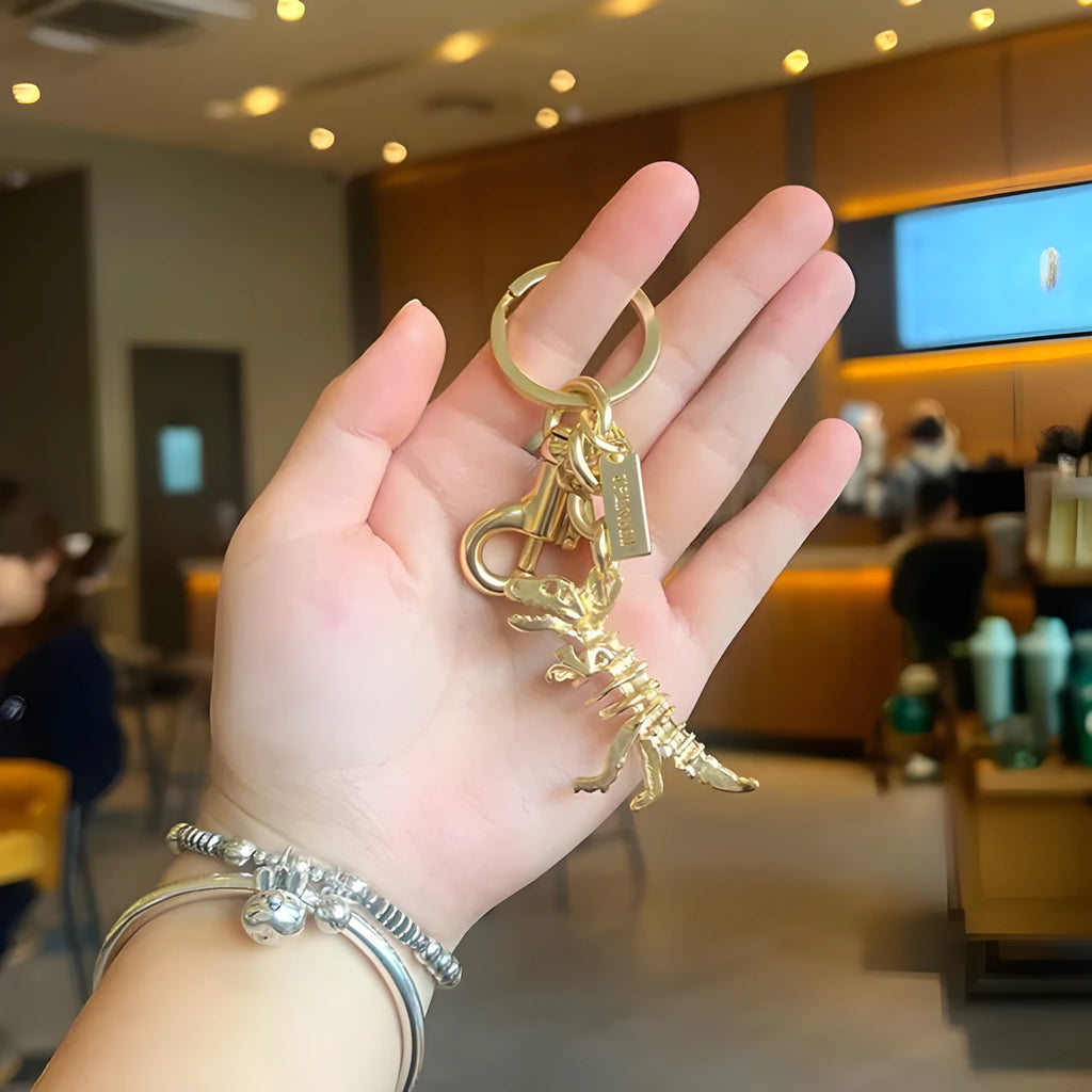 Golden Bone Dragon zinc alloy dinosaur keychain on a white background
