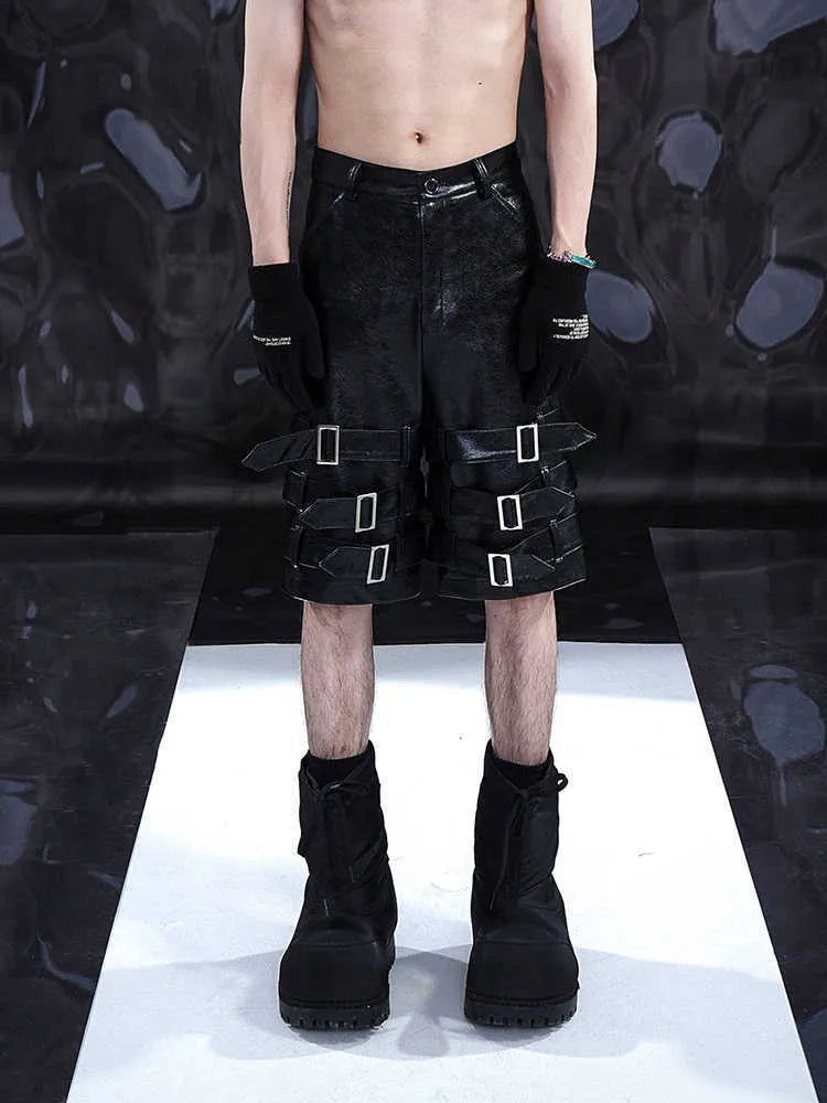 Men's black PU leather casual cropped shorts on a hanger.