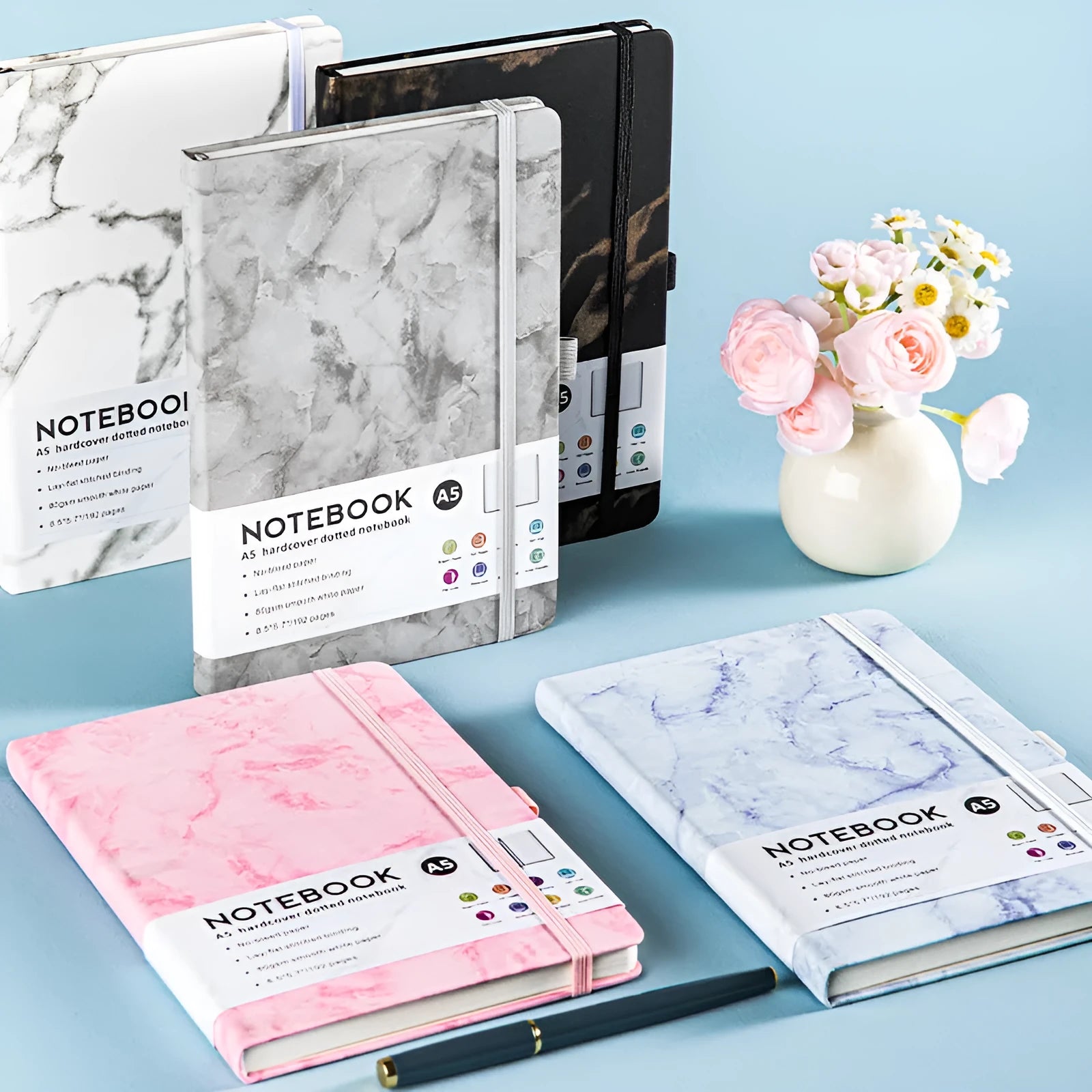 A5 soft-touch PU leather diary with a strap closure, shown open on lined white paper pages.