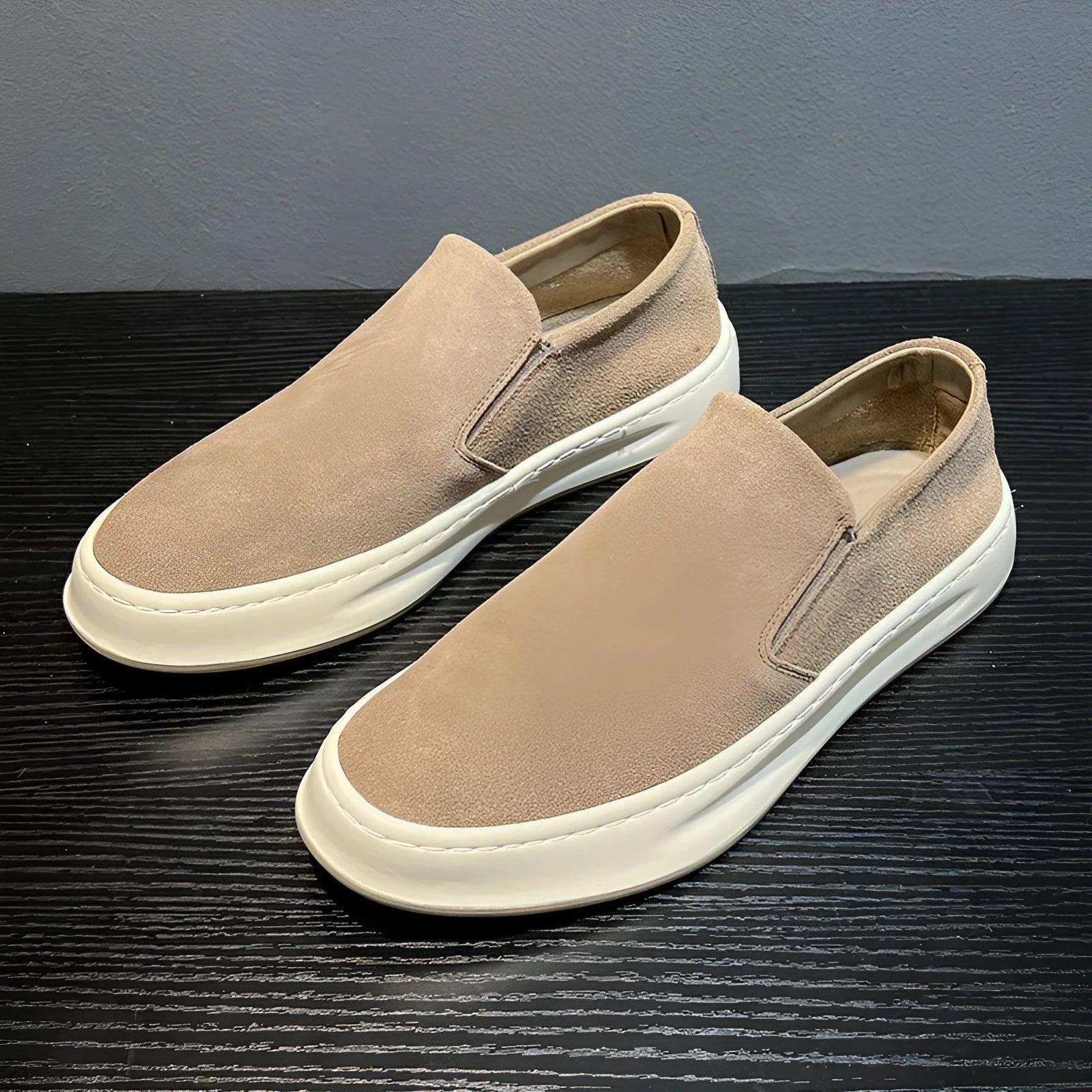 Men's casual slip-on shoes in apricot colour with round toe and mid heel, showing sewing line detail on artificial PU upper