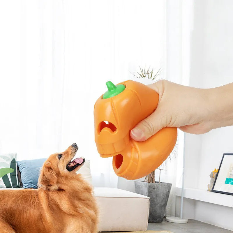 Red and orange Halloween pumpkin shaped interactive dog chew toy on a white background.