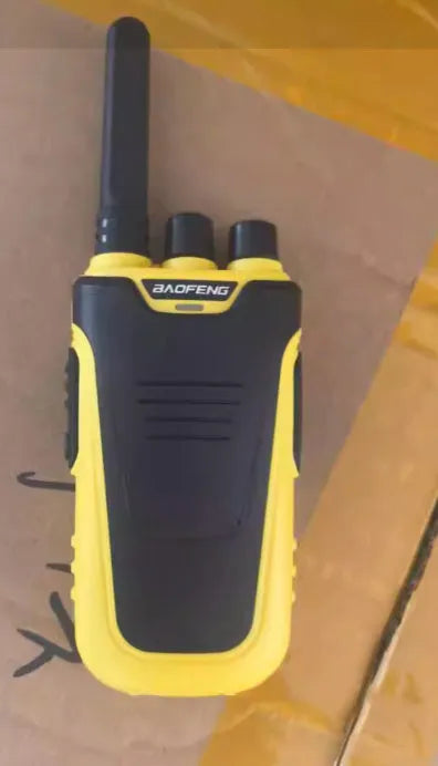 Red and yellow children's walkie talkies showing front display and USB charging port