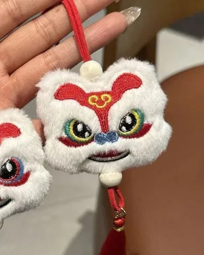 Chinese style plush lion keychain ornament with tassel and star stone accents in blue or yellow