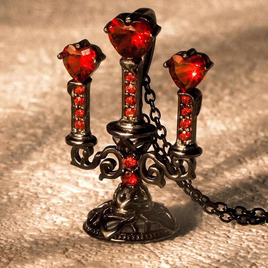 Women's silver Gothic necklace featuring a hollow candlestick pendant on a cross chain.