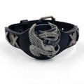 Black geometric bracelet with eagle watch-button closure on leather strap showing adjustable width design
