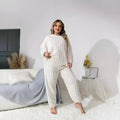 Creamy white women's plush polyester lounge set with crew neck top and matching trousers