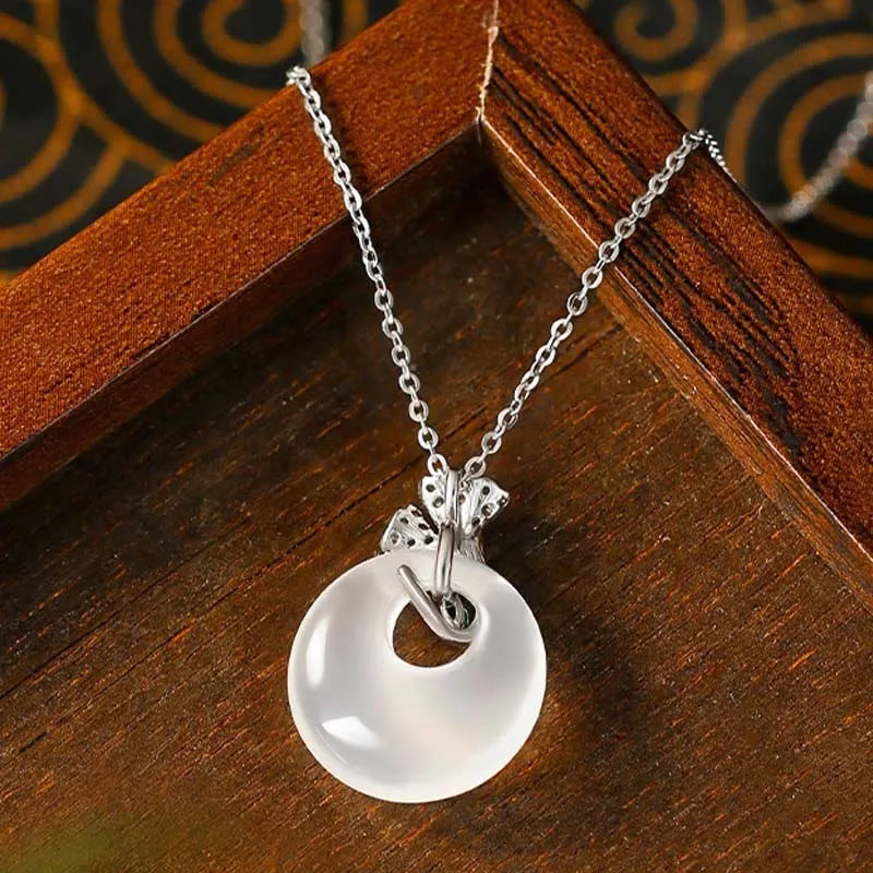 White ginkgo leaf pendant necklace with mixed gem inlay on silver electroplated O-ring chain