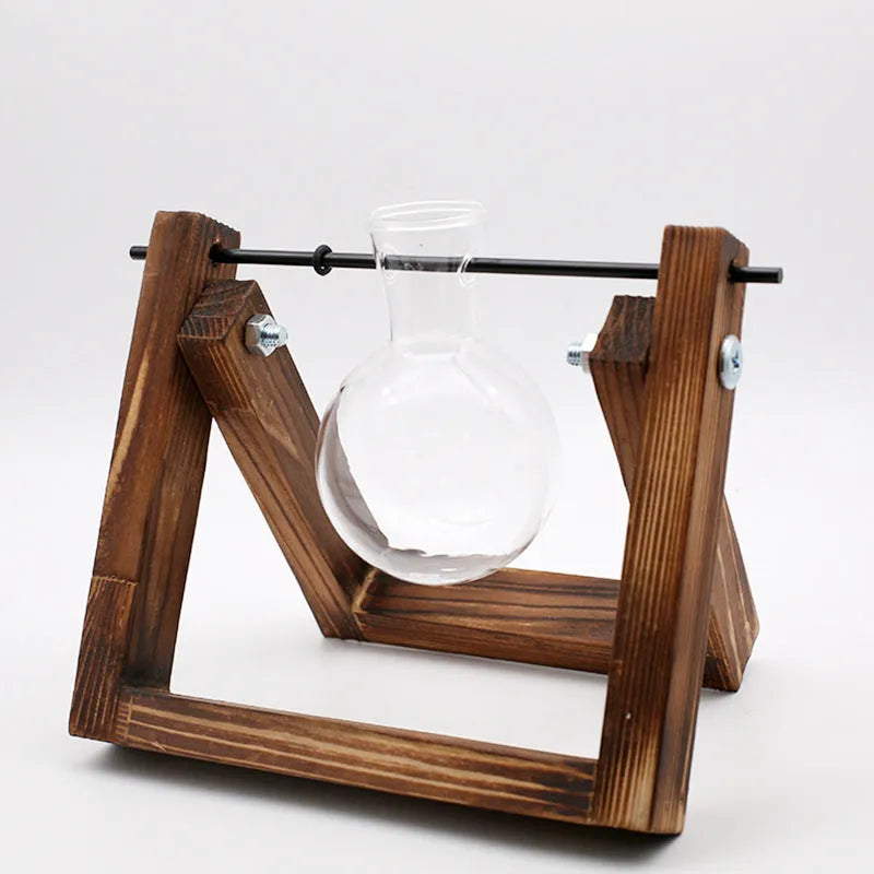 Hydroponic borosilicate glass vase in a wooden swing stand with iron frame, geometric pastoral design for indoor plant display