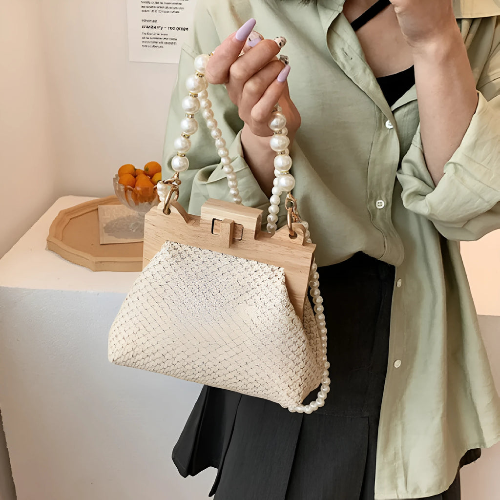 Women's straw shoulder bag with woven pearl chain detail and multiple internal compartments