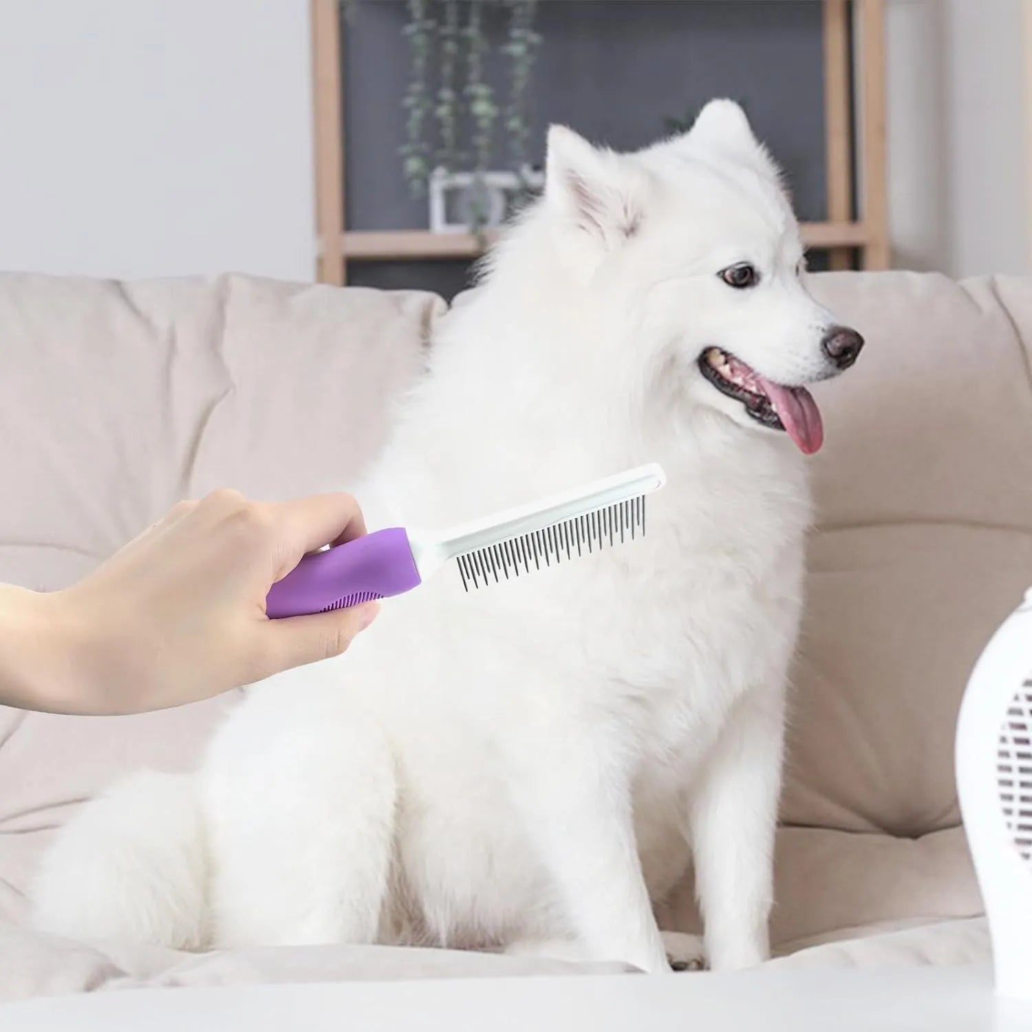 Purple pet grooming comb with stainless steel teeth on an ergonomic handle.