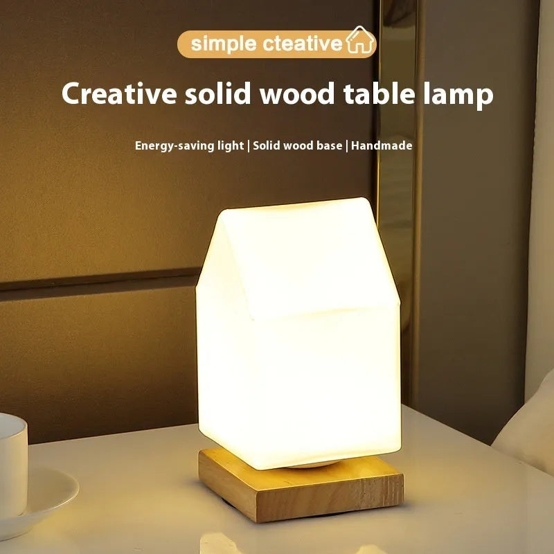 Nordic white geometric table lamp with solid wood base and USB charging port on a wooden desk.