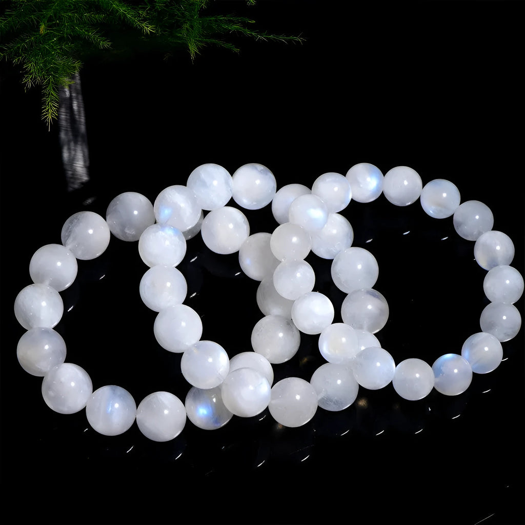 Natural blue moonlight polished round moonstone bead bracelet on a white background.