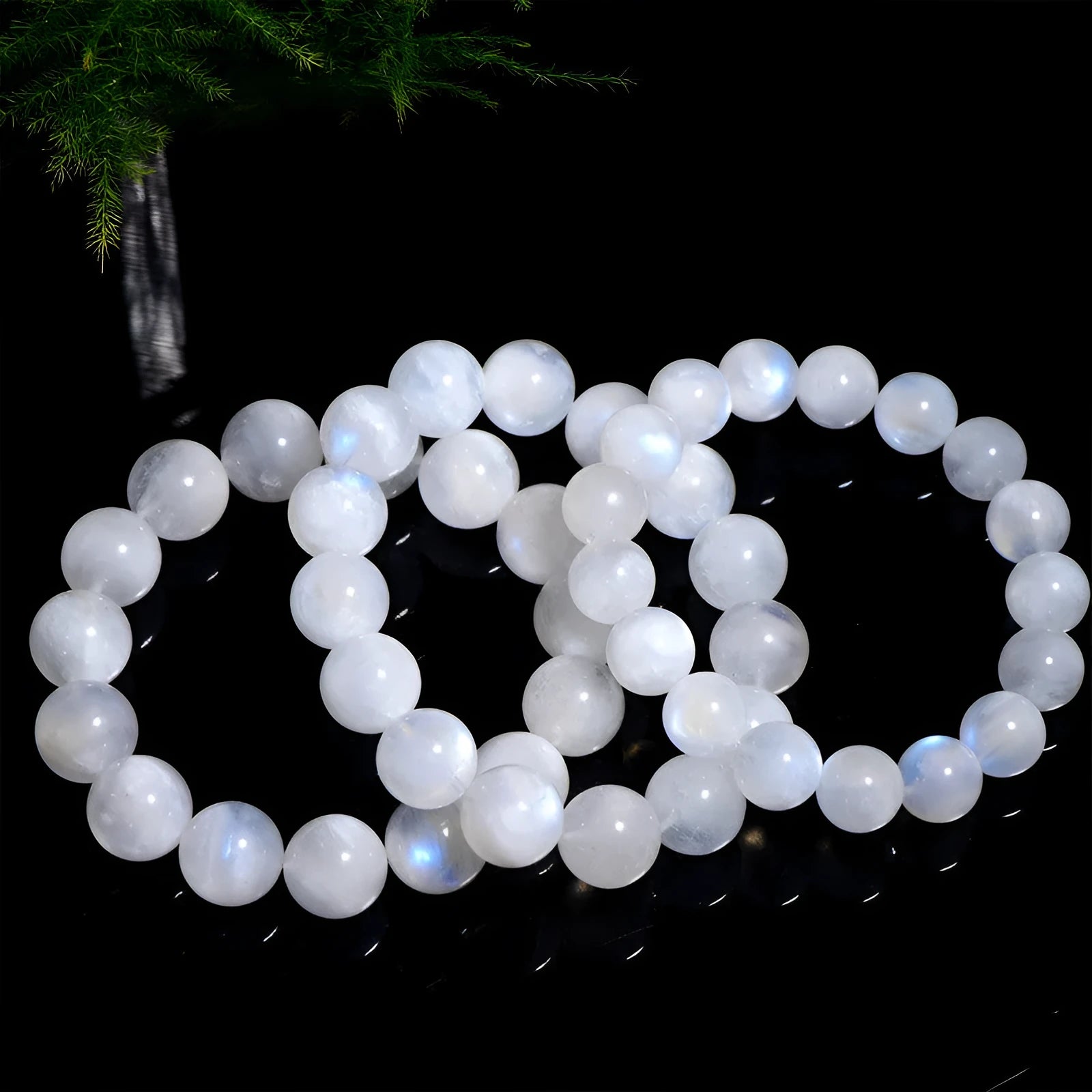 Natural blue moonlight polished round moonstone bead bracelet on a white background.