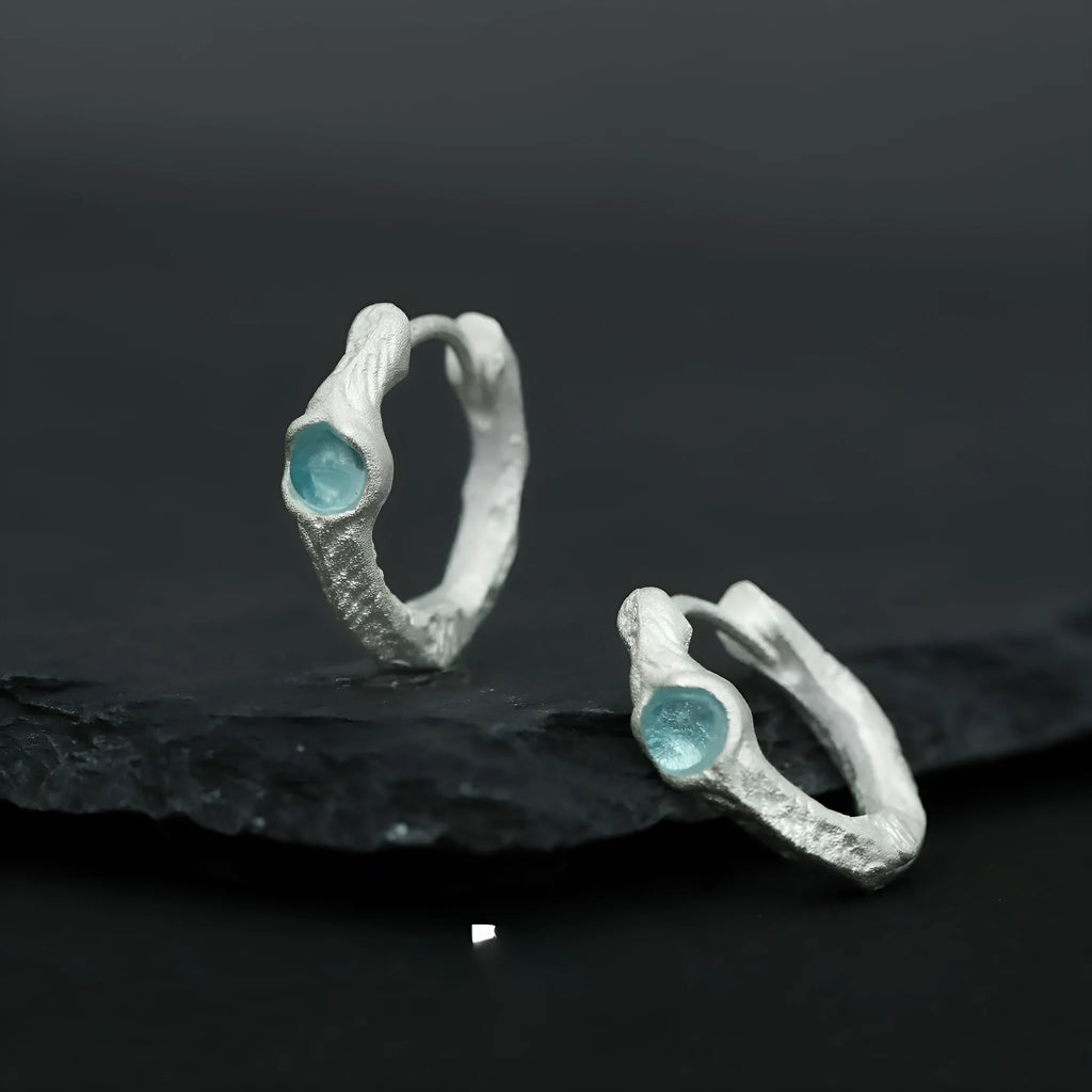 Geometric burnt silver ear clip for women made from 925 silver with round design elements.