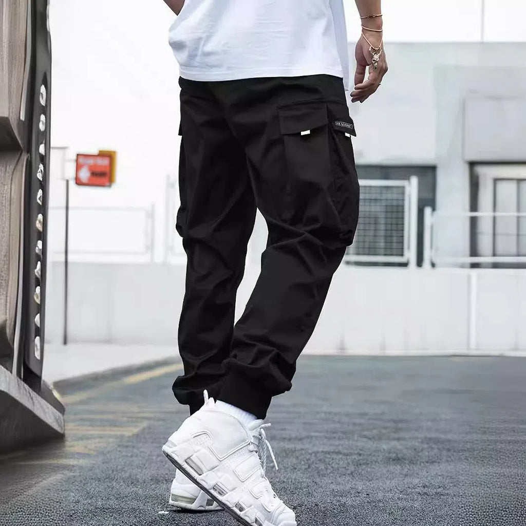 Men's multi-pocket cargo pants in polyester, loose fit, mid waist, drawstring, nine colours, sizes S to 3XL.