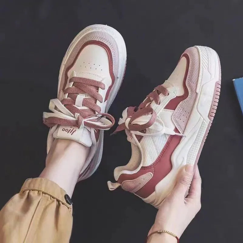 Women's pink and beige low-top sneakers with a rubber sole for height increase.