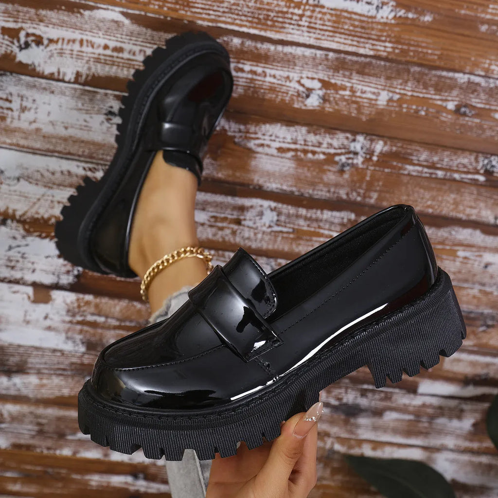 Black chunky heel loafers with a thick rubber sole and platform, shown from the side.