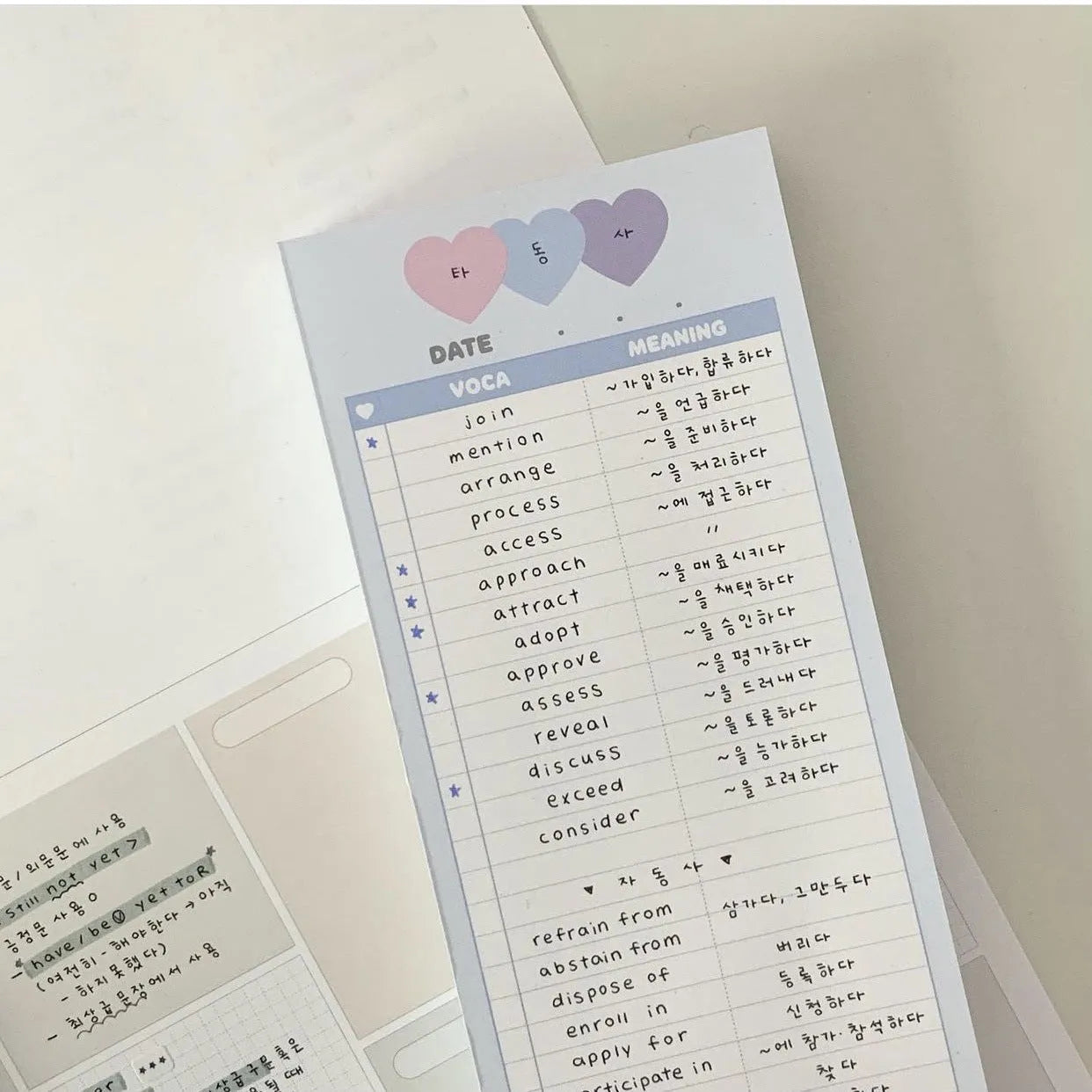 Blue B5 half-size vertical notepad with 30 sheets next to pink and purple versions.