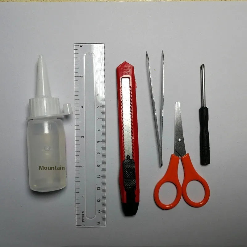 Manual assembly model tool set including scissors, tweezers, ruler, art knife, and glue for craft building