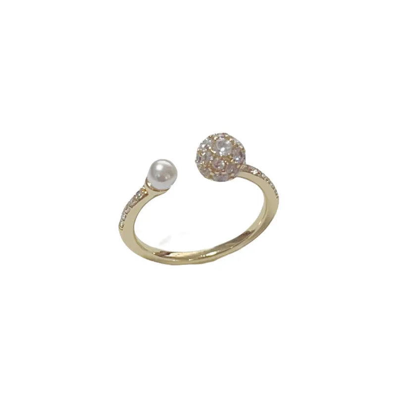 Gold or silver open-end women's ring with round zircon stones on a geometric copper band.