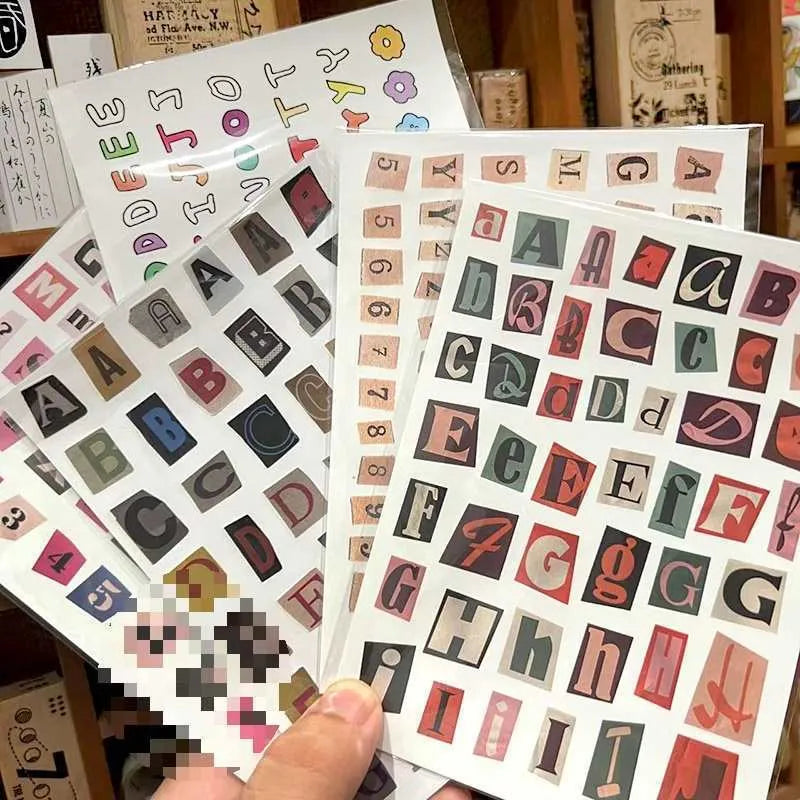 A set of cute-style decoration stickers showing printed English letters and weekly words like Monday, Tuesday.