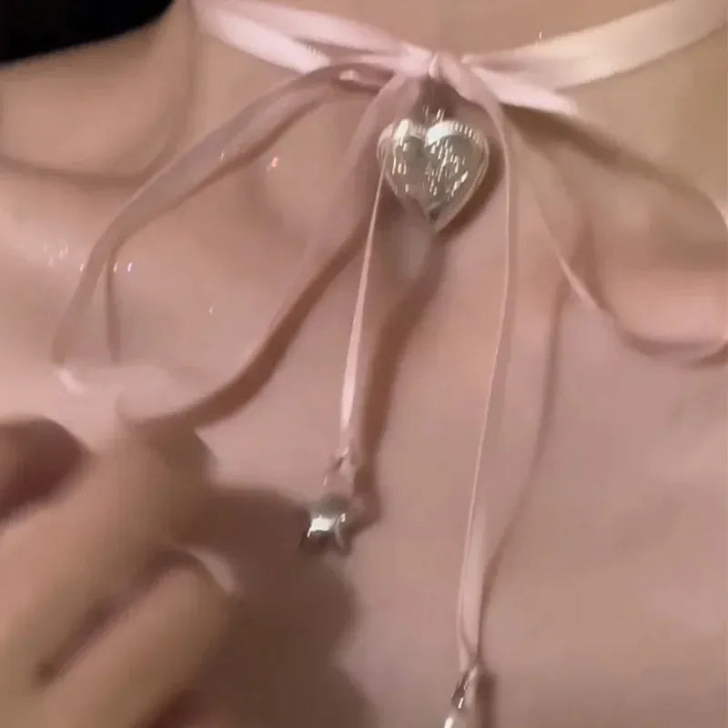 Women's alloy fashion necklace with love pendant and ribbon detail on clavicle chain
