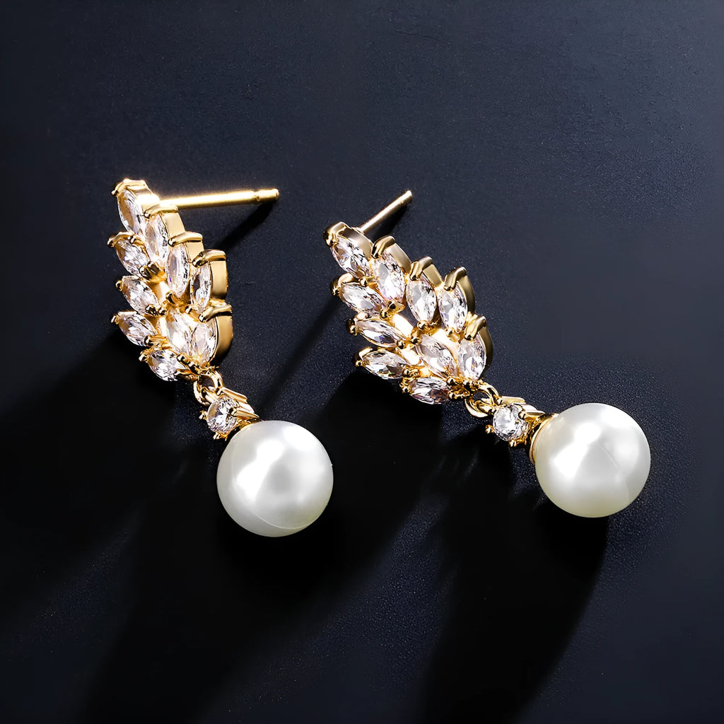 A pair of geometric stud earrings with a flower design and micro inlaid zircon, shown in gold plating.