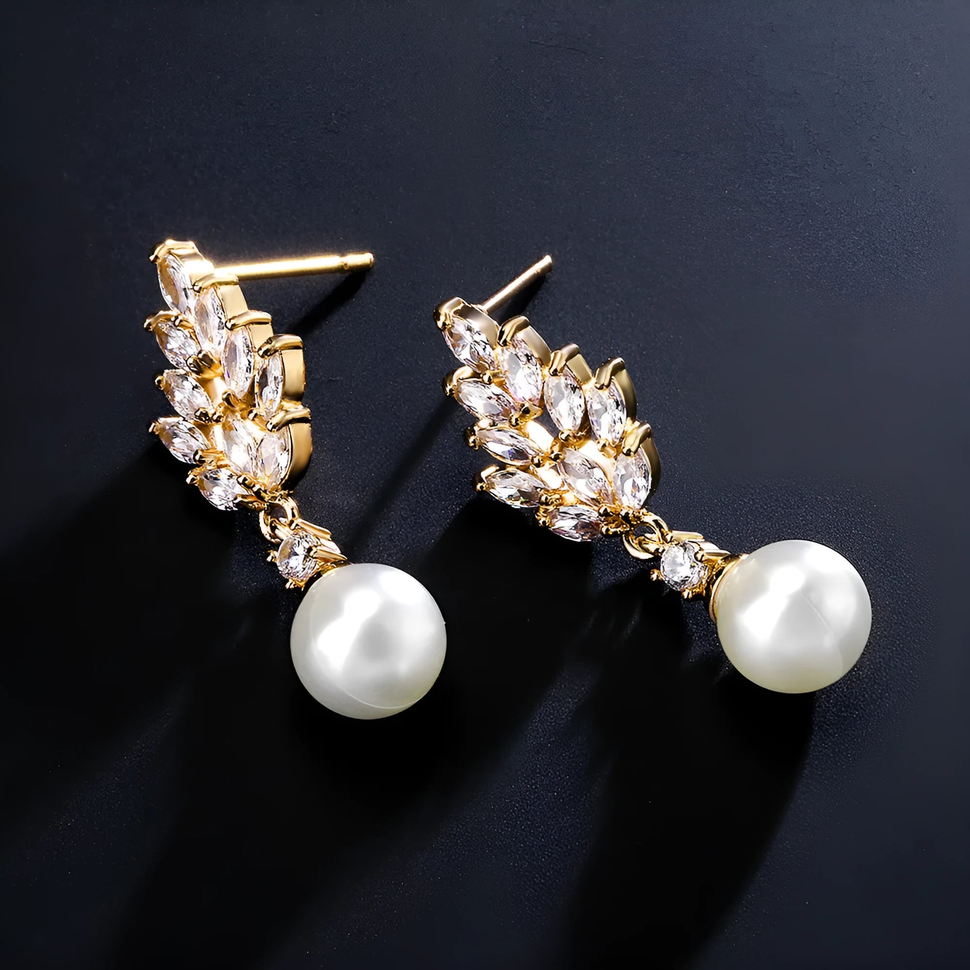 A pair of geometric stud earrings with a flower design and micro inlaid zircon, shown in gold plating.