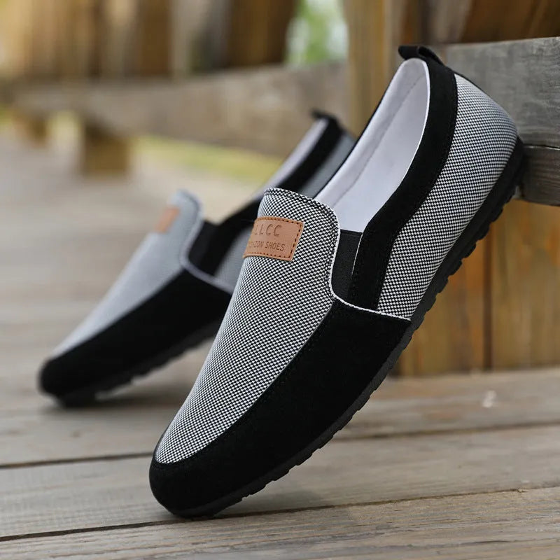 Men's grey canvas board shoes with round toe and rubber sole on a white background.
