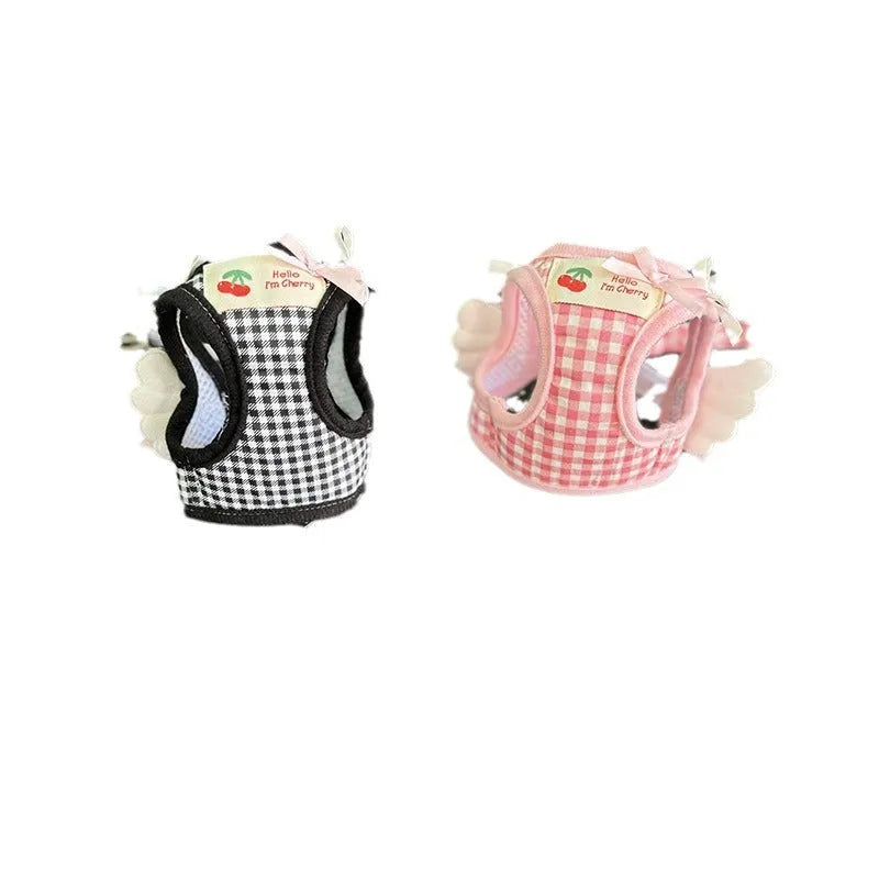 Pink adjustable cotton dog harness with chest and back handle on a small dog.