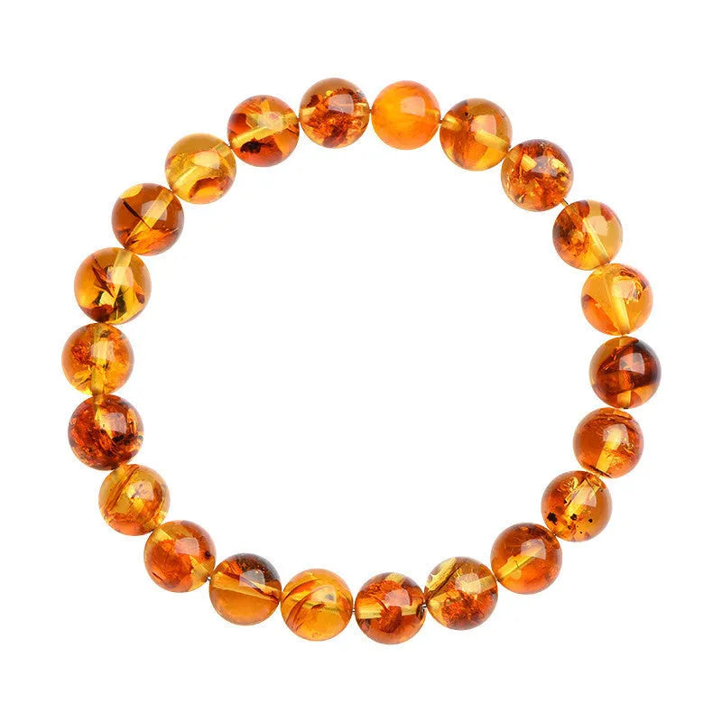 Natural yellow amber bracelet with piebald spots, showing geometric beads on a wrist.