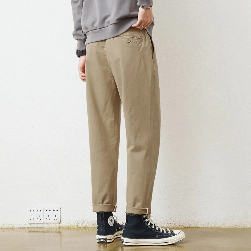 Men's loose wide-leg casual pants in dark khaki with zipper fly and mid-rise waist on a plain background