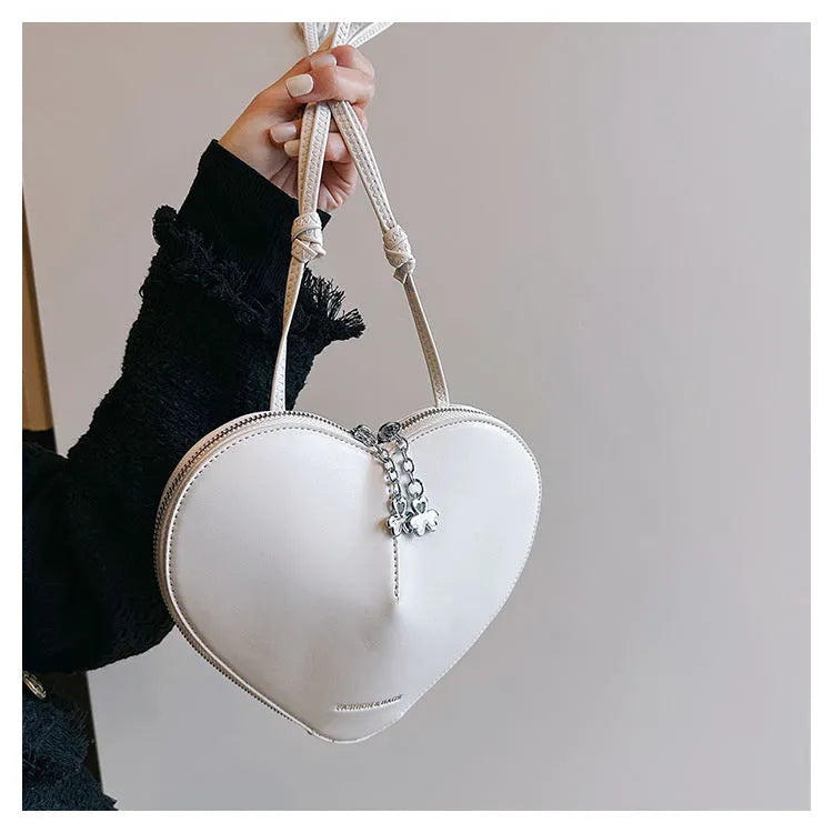 Women's PU leather heart shape crossbody bag in milky white with sewing line design and single shoulder strap