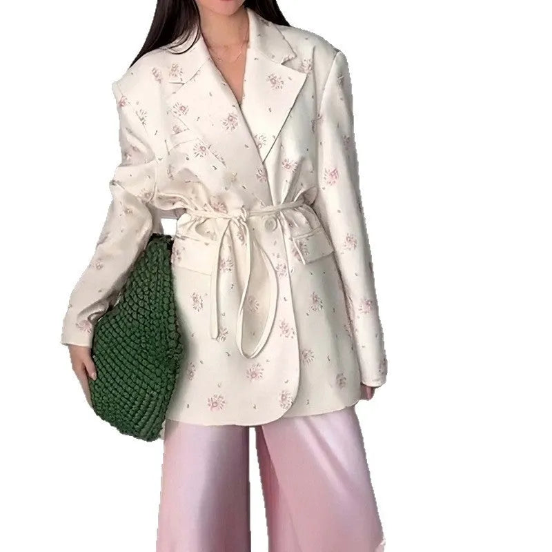 Women's white polyester suit jacket with a lace-up detail cinching the waist.