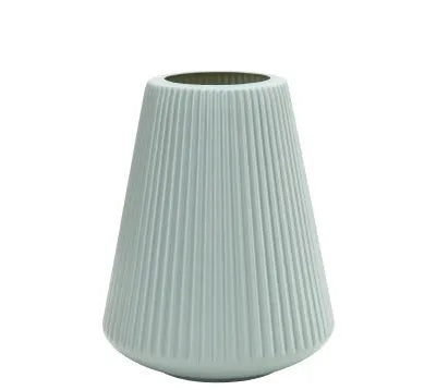 A simple white melamine plastic decorative flower vase on a wooden tabletop.