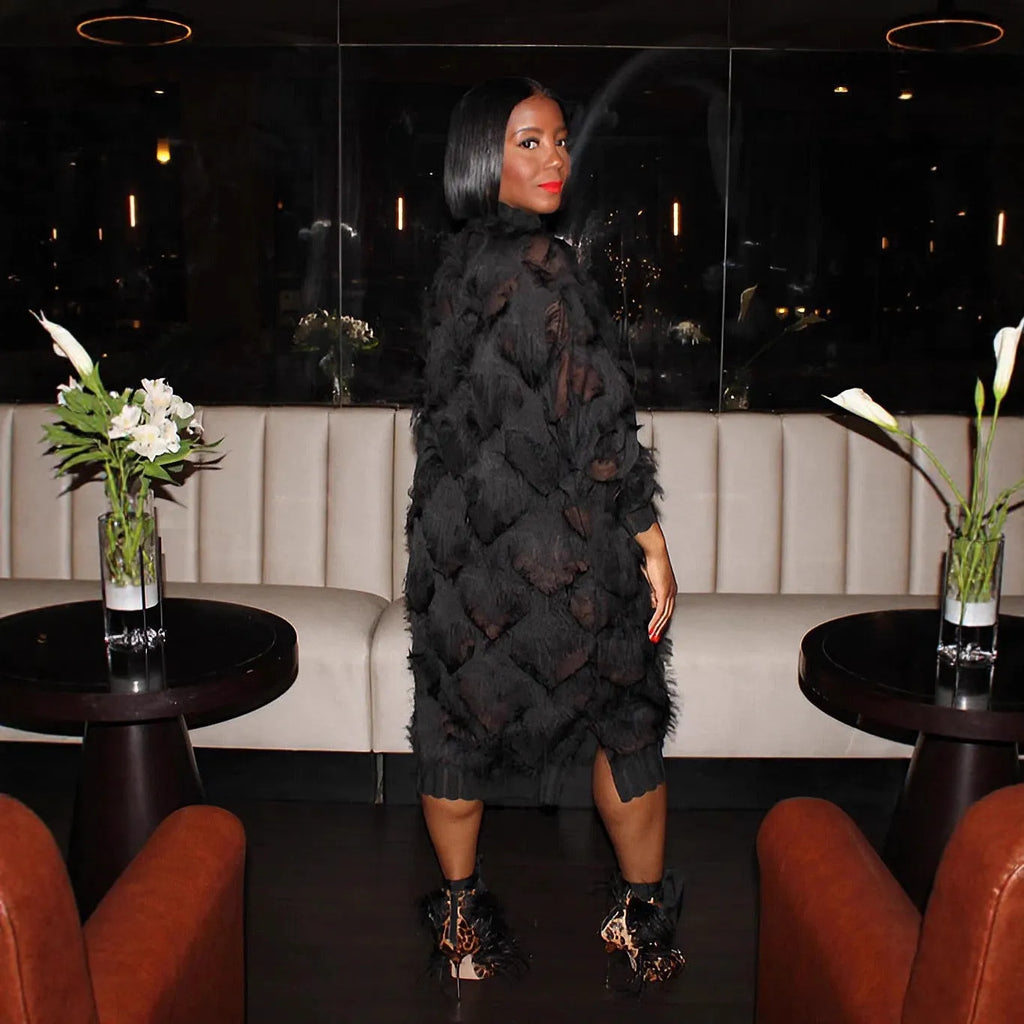 Black chiffon fringe loose mid-length dress with stand collar and long sleeves on a model