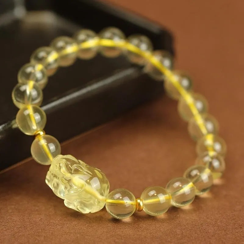 Yellow leather bracelet with a citrine-coloured artificial crystal Pi Xiu charm.