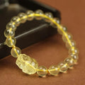 Yellow leather bracelet with a citrine-coloured artificial crystal Pi Xiu charm.